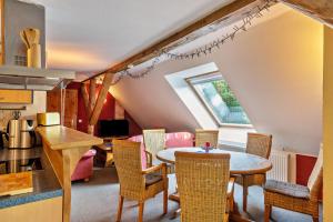 a kitchen and dining room with a table and chairs at Dachstudio Seeblick in Krüselin