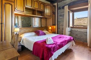 a bedroom with a large bed and a window at La Posada Del Chano in Cerecedo de Besullo