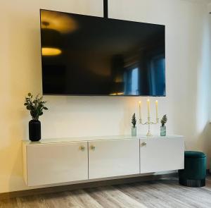 a white cabinet with a tv on top of it at Ferienwohnung Stern in Goslar