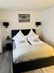 a bedroom with a large bed with white sheets at Ferienwohnung Stern in Goslar