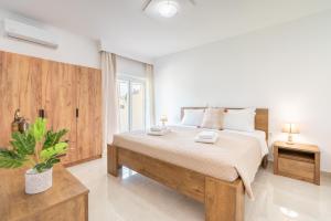 a bedroom with a large bed and a window at Absinthia Fanes in Rhodes Town