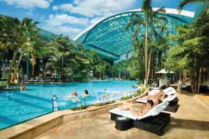 a group of people sitting in chairs in a swimming pool at a resort at Gästehaus Schwörer in Lenzkirch