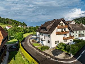 a house in a village with a winding road at Gästehaus Schwörer in Lenzkirch