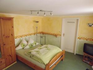 a bedroom with a bed and a television at Ferienwohnungen Sonnenblumenhaus in Bamberg