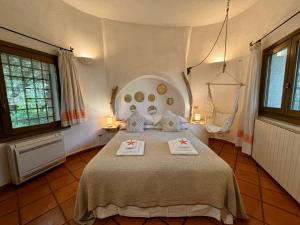 a bedroom with a bed with two towels on it at Villa Nuraghe in Porto Rotondo +32 photos