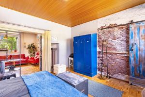 a bedroom with blue doors and a brick wall at Happy Place Indu Style in Korbach