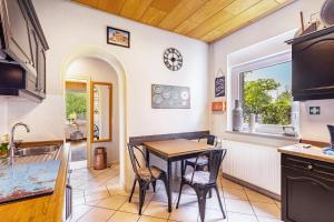a kitchen and dining room with a table and chairs at Happy Place Indu Style in Korbach