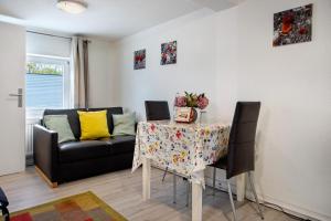 a living room with a table and a couch at Bäckerhus - Ferienwohnung 2 in Wiek auf Rügen +15 photos