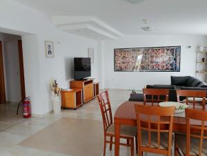 a living room with a table and a couch at Castle & Sea-Panorama Penthouse in Haraki