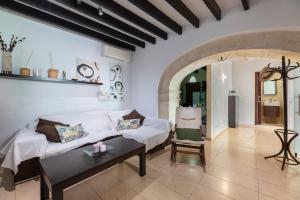 a living room with a white couch and a table at Casa típica mallorquina en Sa Pobla in Sa Pobla