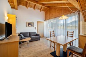 a living room with a couch and a table at Residence Linderhof in Natz-Schabs