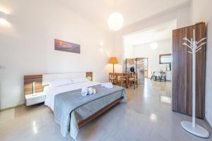 a bedroom with a bed and a living room at Melissa apartments in Halikounas