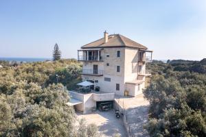an aerial view of a house on a hill with trees at Melissa apartments in Halikounas
