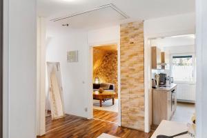a living room with white walls and a brick wall at Ferienwohnung Nickel in Hofstetten