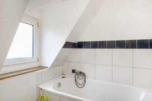 a bathroom with a white tub and a window at Ferienwohnung Nickel in Hofstetten +18 photos