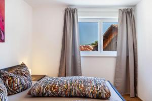 a room with a window and a bed with a pillow at Manu's Bergblick in Arzl im Pitztal