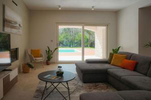 a living room with a couch and a table at Villa Lapidea in Bezjaki
