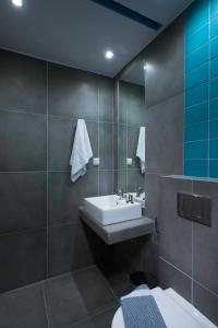 a bathroom with a sink and a mirror at Fresh Mare Apartments in Limenaria