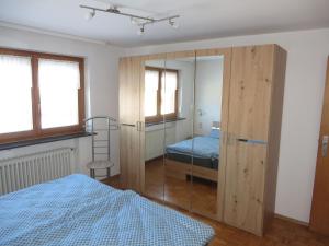 a bedroom with a bed and a glass closet at Ferienwohnung Stadtblick in Bräunlingen +3 photos