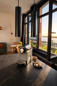 a kitchen with a table with bread on a counter at SLEEP INN - Kaai11, Riverview Lofts & Suites in Antwerp