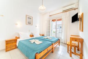 a bedroom with a bed with two towels at Olivea Studio 2 in Acharavi
