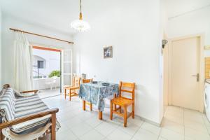 a living room with a table and chairs at Olivea Studio 2 in Acharavi