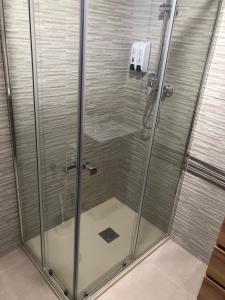 a shower with a glass door in a bathroom at Geranio in Caserío Bacarot +21 photos