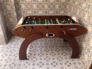 a wooden foosball table with a game in it at Geranio in Caserío Bacarot
