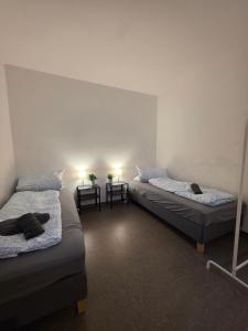 two beds in a room with two tables at Relax after work in Ochsenhausen