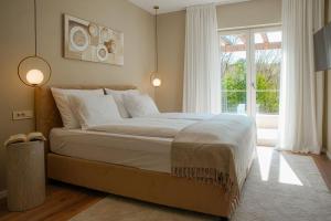 a bedroom with a large bed and a window at Villa Lapidea in Bezjaki +39 photos