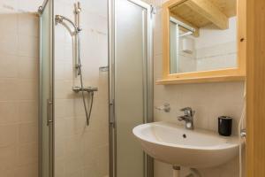a bathroom with a sink and a shower at Appartamento Adamello 15 in Pinzolo +31 photos