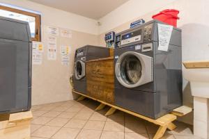 a laundry room with two washing machines on a shelf at Appartamento Adamello 15 in Pinzolo