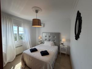 a bedroom with a bed with two towels on it at Villa Mansory in Lloret de Mar +34 photos