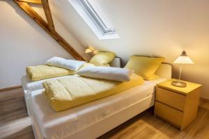a bedroom with a bed with yellow pillows at Ferienwohnung Degen in Donaueschingen