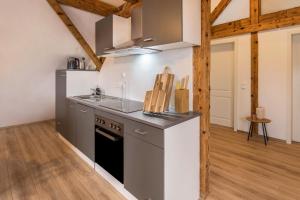 a kitchen with a sink and a stove top oven at Ferienwohnung Degen in Donaueschingen
