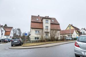a house on a street with cars parked on the street at Ferienwohnung Degen in Donaueschingen