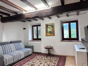a living room with a couch and a table at La casa della nonna in Serramazzoni