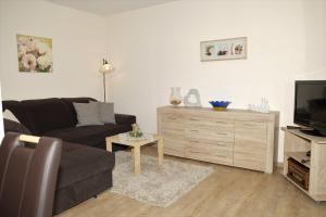 a living room with a couch and a tv at Ferienwohnung Poll in Wimbach