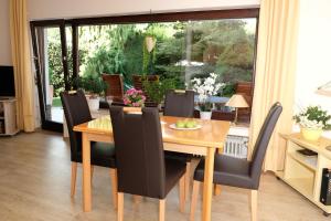 a dining room with a wooden table and chairs at Ferienwohnung Poll in Wimbach +8 photos