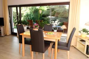 a dining room with a wooden table and chairs at Ferienwohnung Poll in Wimbach