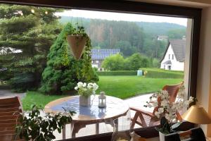 a window view of a patio with a table at Ferienwohnung Poll in Wimbach