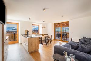 a kitchen and living room with a couch and a table at Residence Linderhof in Natz-Schabs