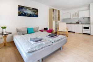 a bedroom with a bed and a kitchen at Ferienwohnung Adrion in Bad Herrenalb