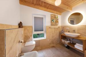 a bathroom with a sink and a toilet and a window at Ferienhaus mit Panoramablick in Gernrode +27 photos