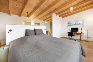 a bedroom with a large bed and a desk at Ferienhaus mit Panoramablick in Gernrode