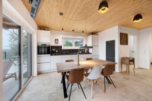 a kitchen and dining room with a wooden table and chairs at Ferienhaus mit Panoramablick in Gernrode