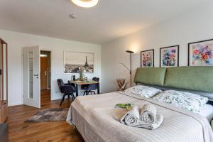 a bedroom with a bed and a desk in a room at Berg und Tal Apartment in Brilon