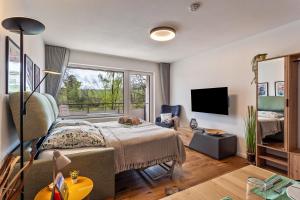 a living room with a bed and a window at Berg und Tal Apartment in Brilon