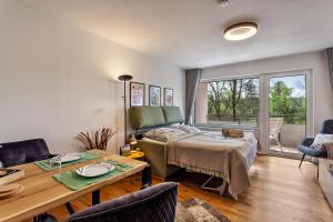 a living room with a bed and a table at Berg und Tal Apartment in Brilon