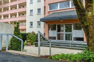 a house with a porch and a building at Berg und Tal Apartment in Brilon